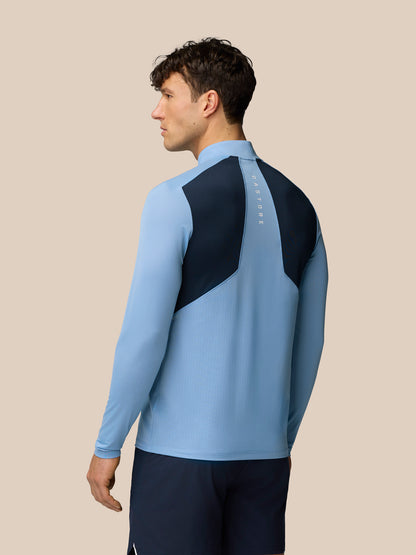 Back view of sky blue Apex Training top with dark shoulder panels and Castore branding along the spine
