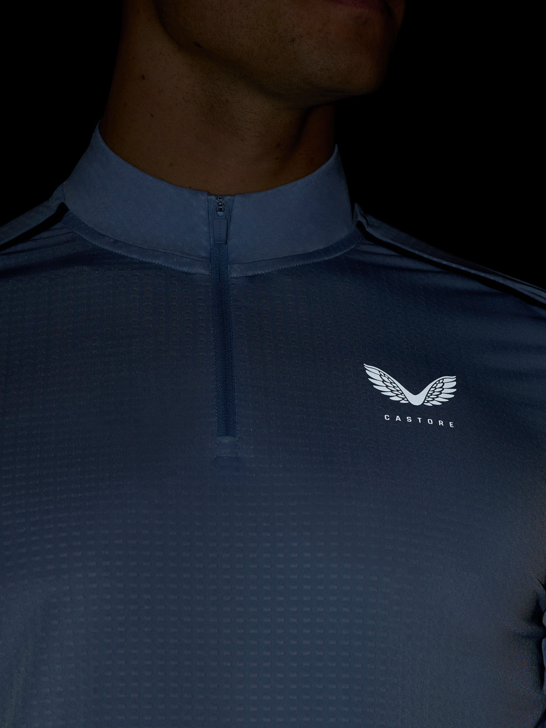 Close up of sky blue Apex Training 1/4 Zip Top showing the collar and center front zip with Castore logo on the chest