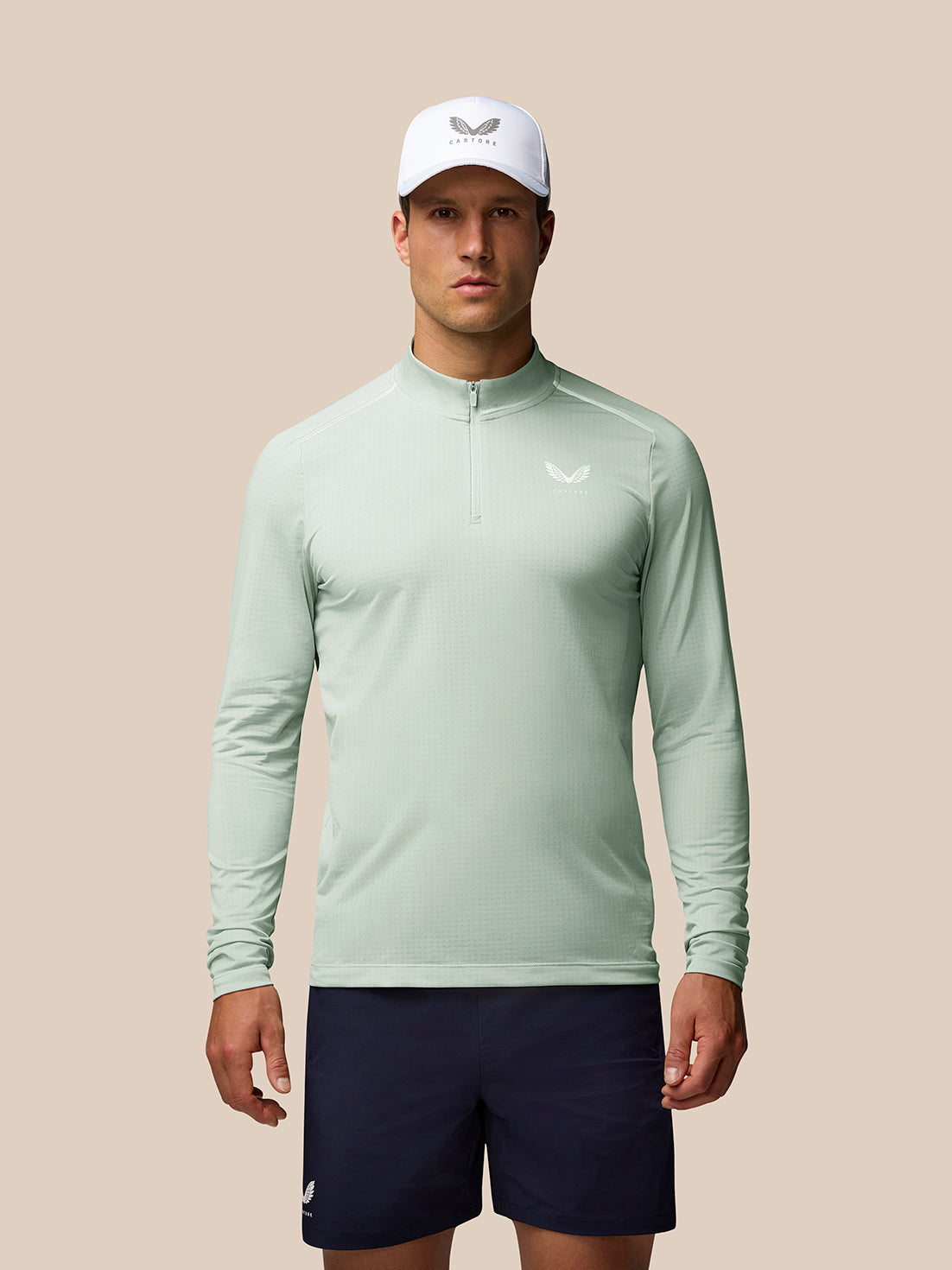Male model wearing a mint green Apex Aeromesh long sleeve quarter zip top suitable for training.