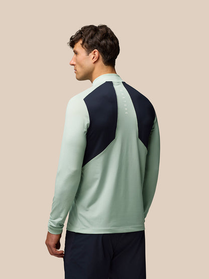 Back view of the mint green Apex Aeromesh long sleeve top with navy color panels and reflective branding.