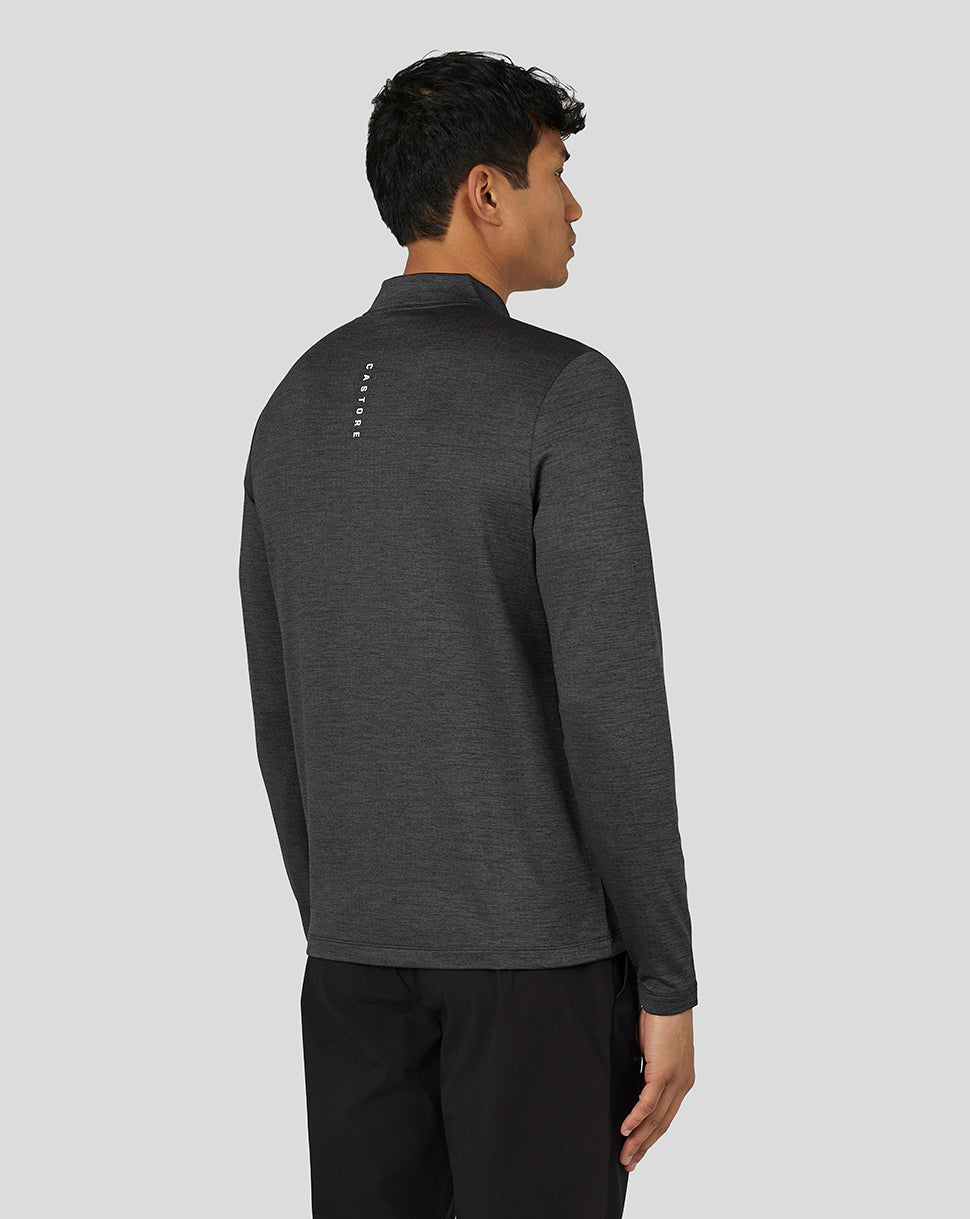 Back view of a male model in the dark gray Marl Quarter Zip with Castore branding along the upper back