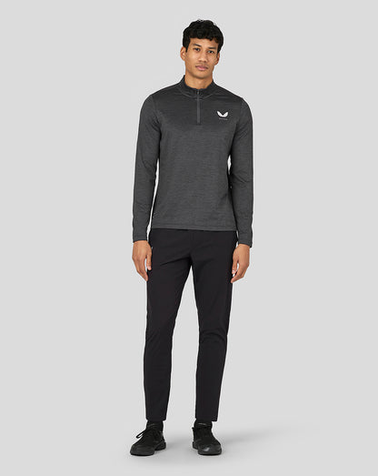 Front view of a male model wearing the dark gray Marl Quarter Zip with left chest logo and black athletic pants