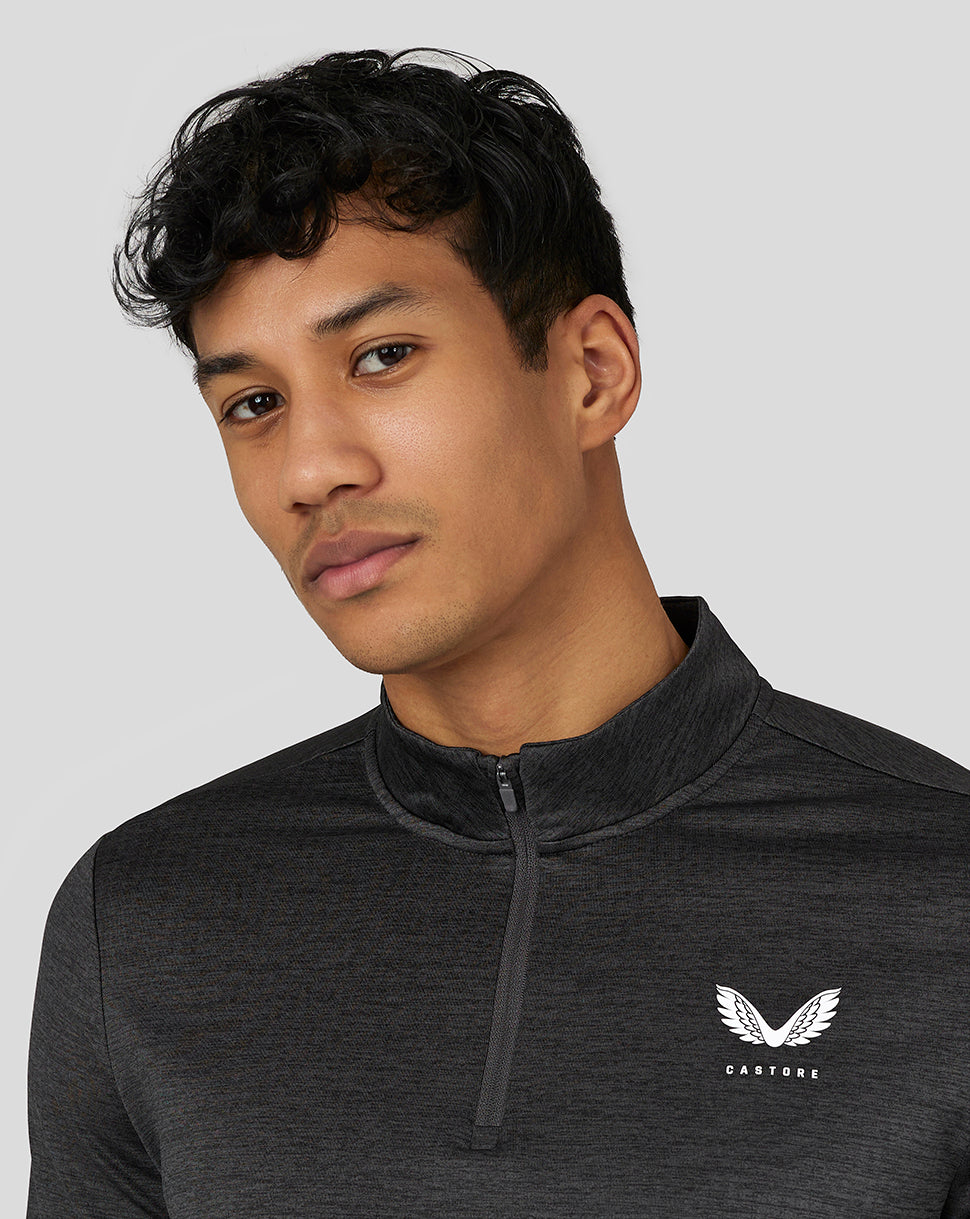 Close-up of a male model wearing a dark gray Marl Quarter Zip with Castore logo on the chest