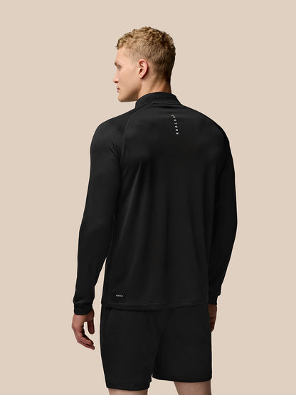 Back view of man wearing Adapt Training quarter-zip top in black with branding visible at the upper back