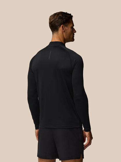 Back view of male model in black Adapt Training top showing branded back neck tape.