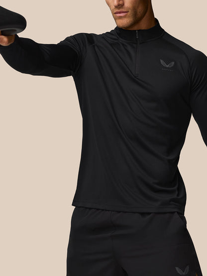 Model wearing Adapt Training 1/4 Zip Top in black with quarter zip and raglan sleeves