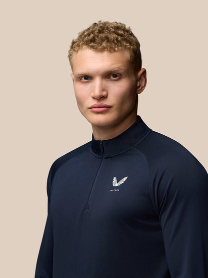 Front view of navy Adapt Training 1/4 Zip Top with stand collar and small Castore logo on the left chest