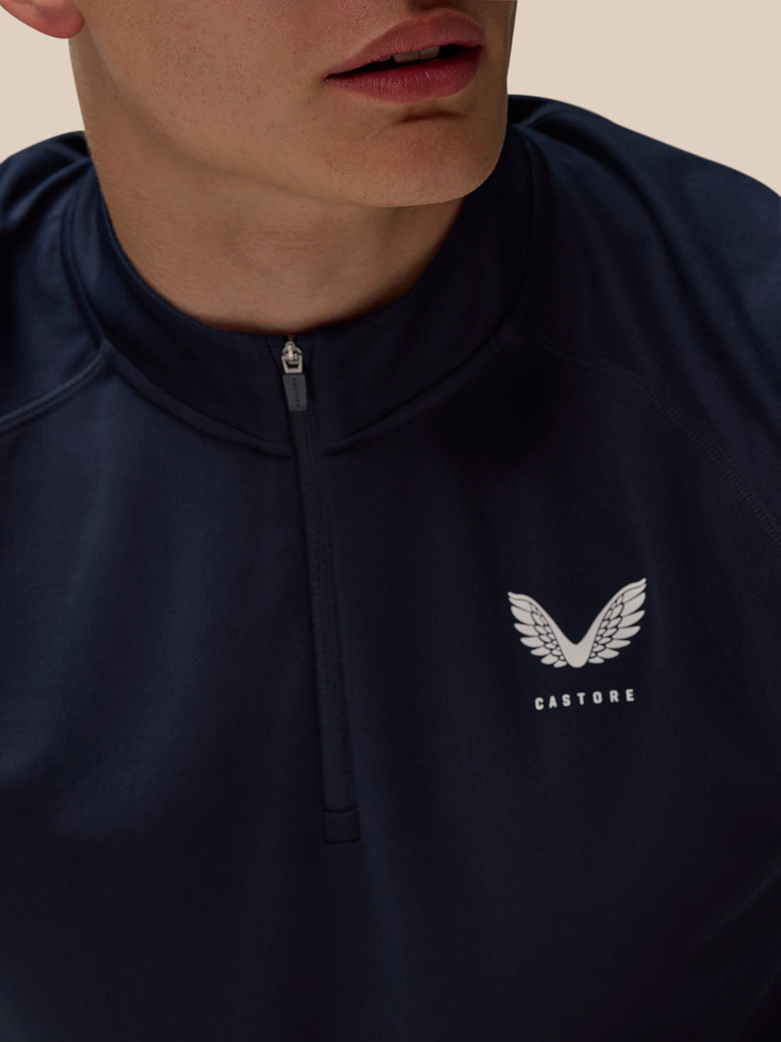 Navy Adapt Training quarter-zip top with stand collar and front zipper, Castore logo on the left chest.