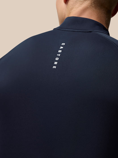 Close up of navy Adapt Training top back featuring vertical Castore branding along the spine