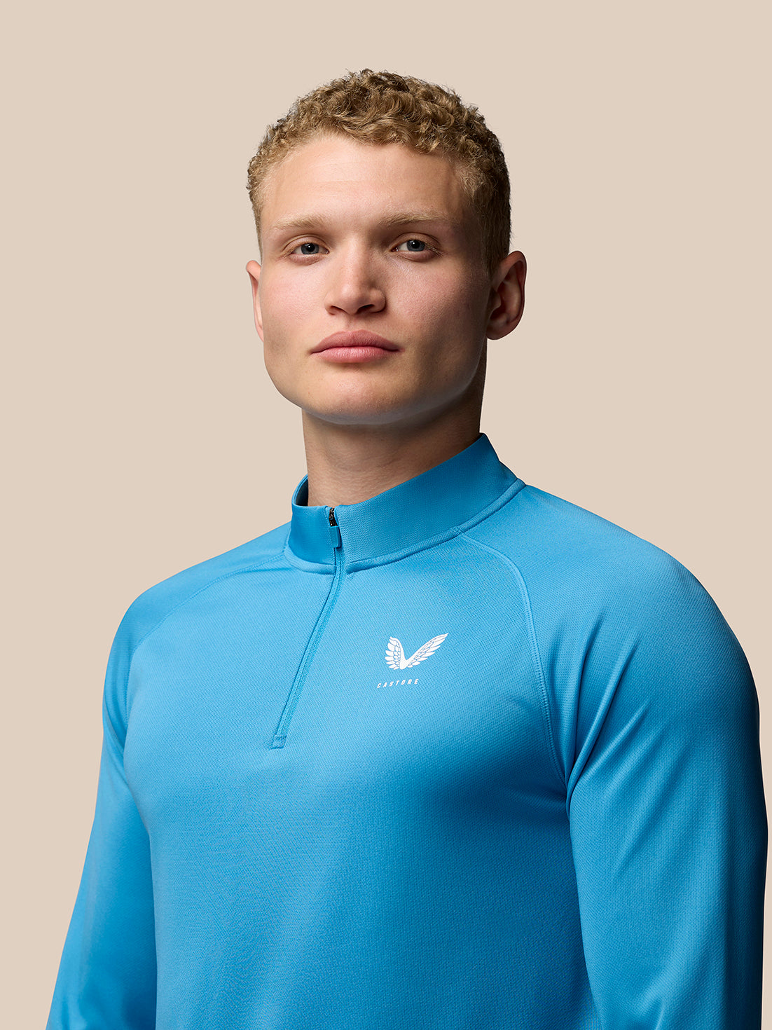 Rear view of corn blue Adapt Training 1/4 Zip Top with Aertek branding at lower left back