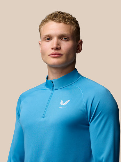 Rear view of corn blue Adapt Training 1/4 Zip Top with Aertek branding at lower left back