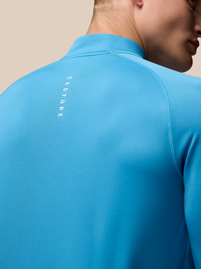 Back view of corn blue Adapt Training 1/4 Zip Top with vertical Castore branding on the back.