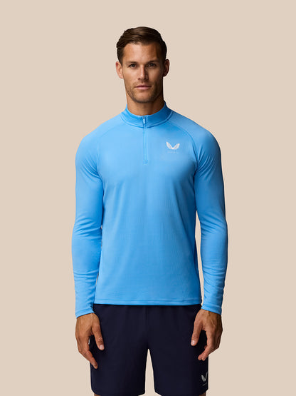 Male model in blue Adapt Training 1/4 Zip Top with logo on chest.
