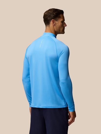 Back view of blue Adapt Training 1/4 Zip Top showing vertical Castore branding on the upper back