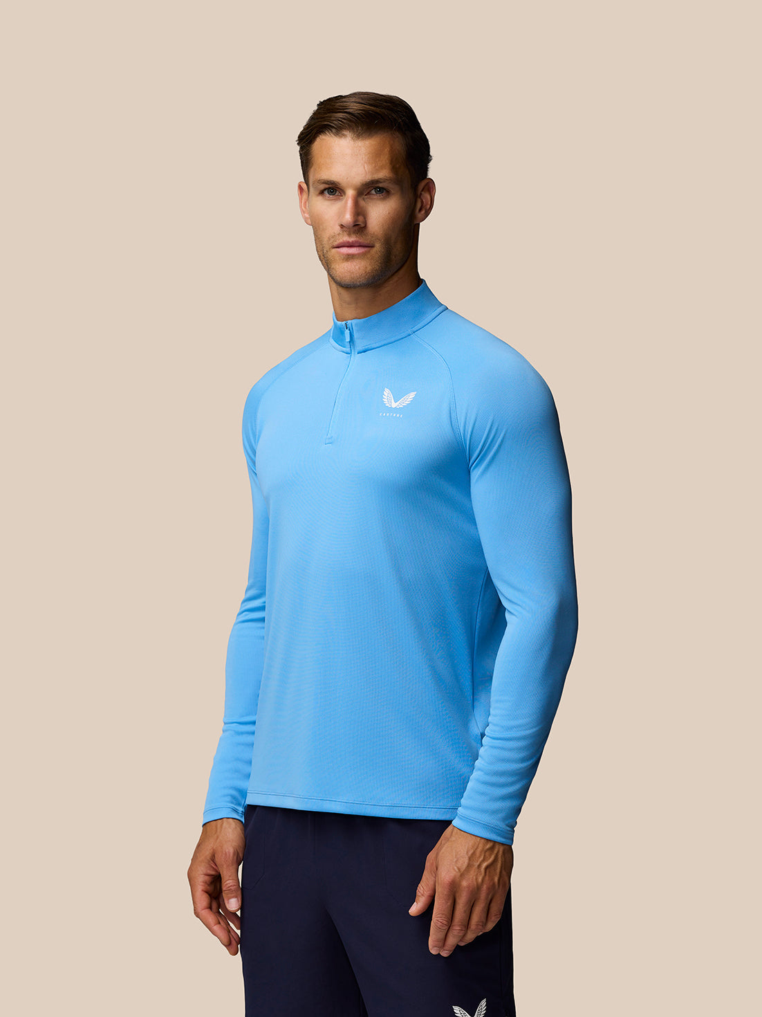 Male model wearing Cool Blue Adapt Training 1/4 Zip Top with long sleeves and zip front.