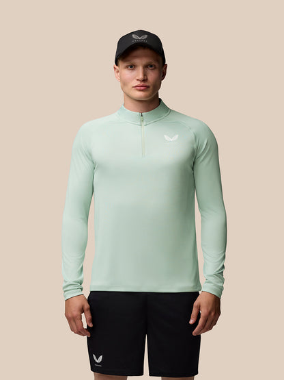 Male model in mint green Adapt Training 1/4 Zip Top with stand collar.