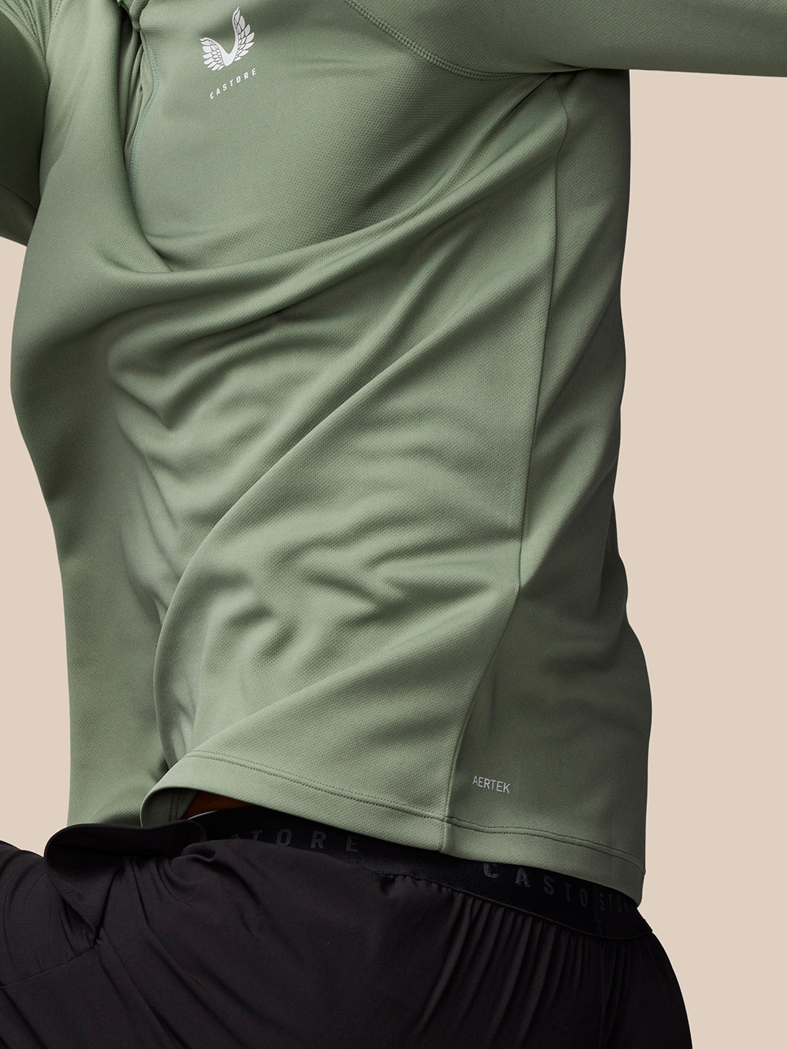 Back close-up of Thyme Mint Adapt Training 1/4 Zip Top, highlighting textured mesh fabric and the Castore logo along the shoulder.