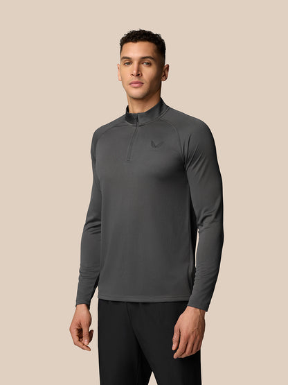 Male model wearing gunmetal Adapt Training quarter zip top with high collar and left chest logo