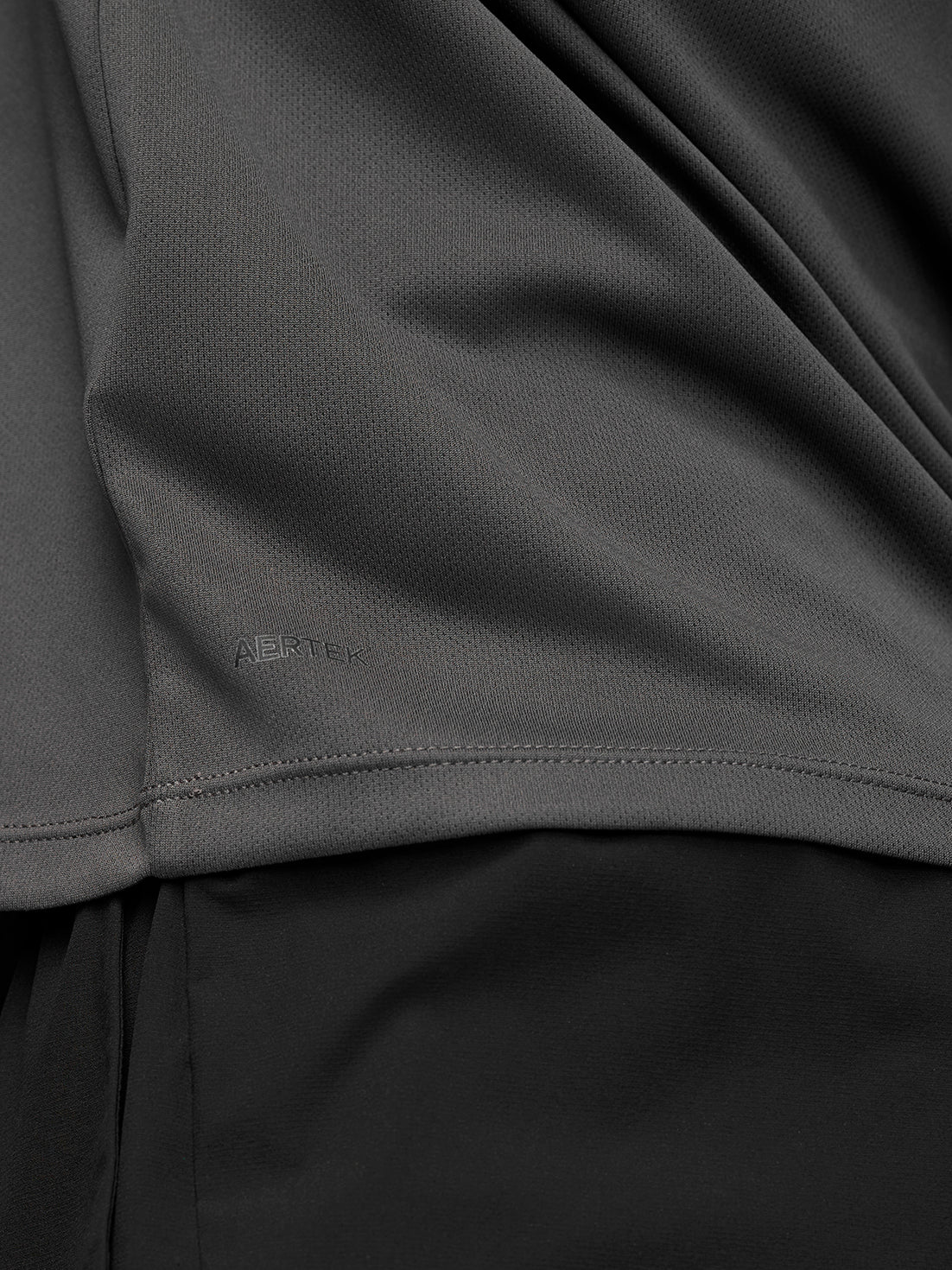 Male model wearing gunmetal Adapt Training ¼ Zip top with raglan long sleeves and quarter zip