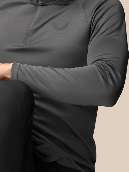 Close up of the chest area on a gunmetal Adapt Training 1/4 Zip Top showing textured fabric and Castore logo on the left chest