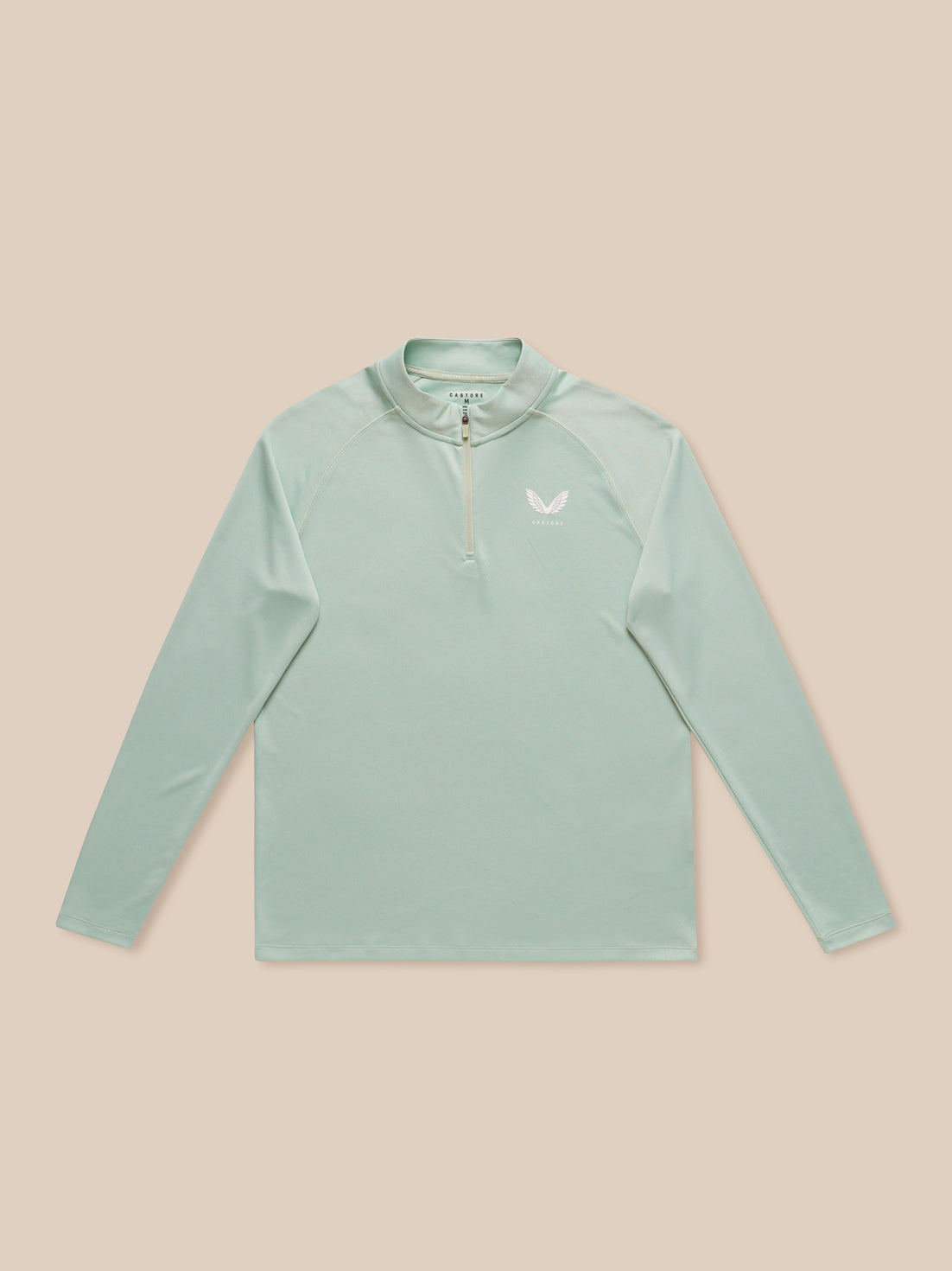 Male model wearing mint green Adapt Training long sleeve quarter zip top with stand collar and chest branding.