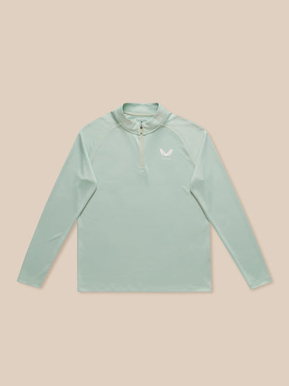 Male model wearing mint green Adapt Training long sleeve quarter zip top with stand collar and chest branding.