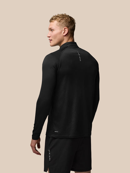 Back view of black Adapt Training top with subtle geometric texture and Castore branding at upper back.