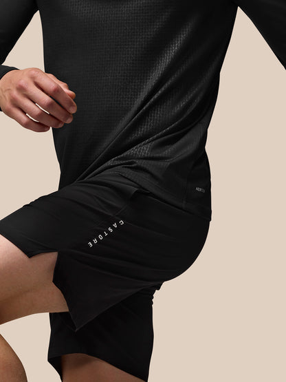 Back view of black Adapt Training long sleeve top with all over geometric pattern and Aertek branding at lower back