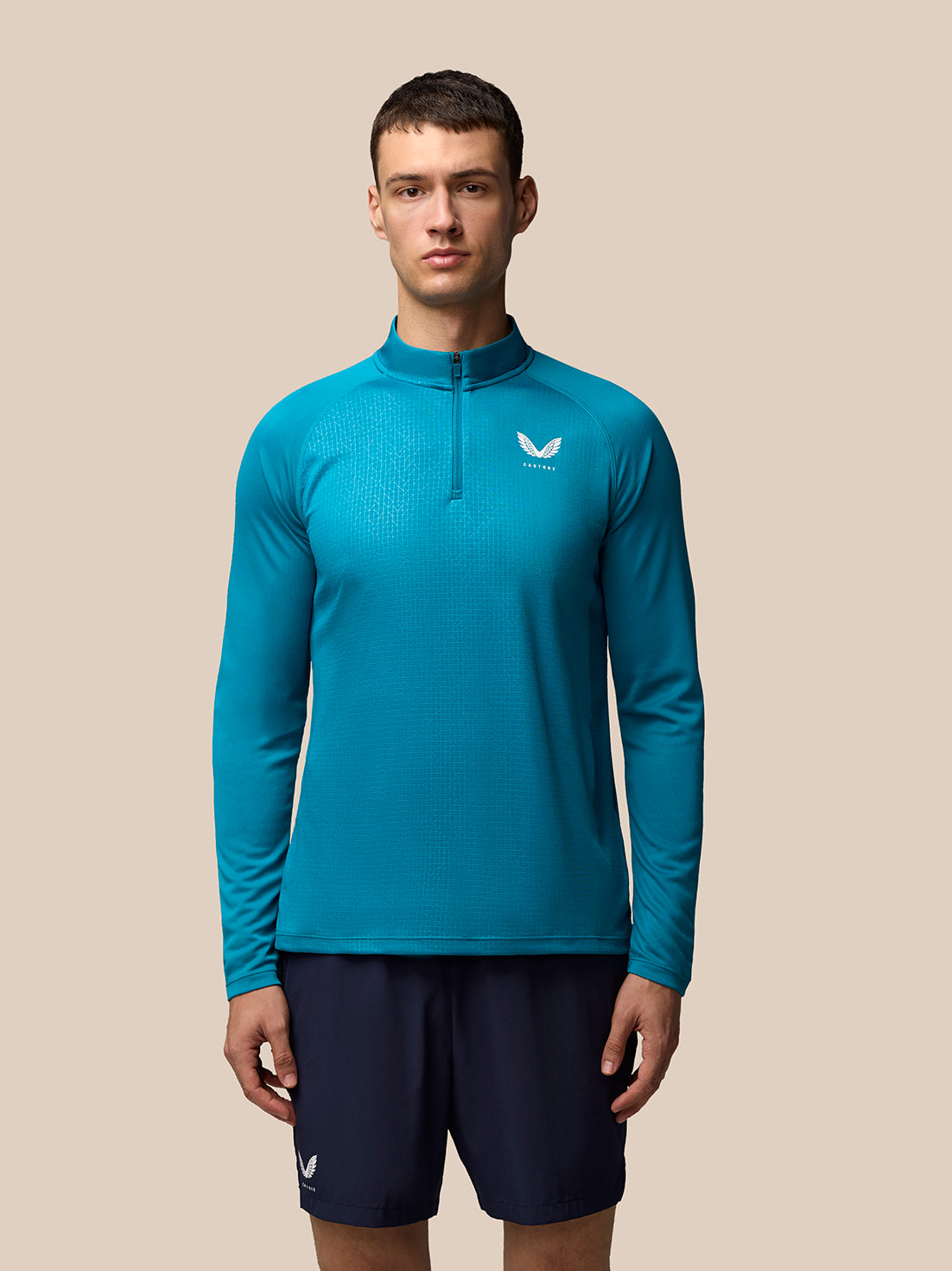 Men's Adapt Print 1/4 Zip Top in Dark Aqua worn by model with stand collar and geometric print