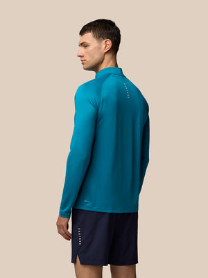 Back view of Men’s Adapt Print 1/4 Zip Top in Dark Aqua on model showing long sleeves and stand collar