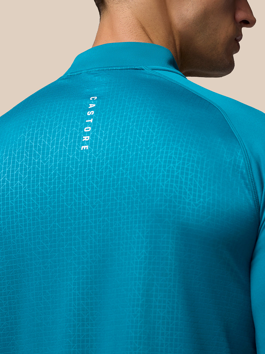Back view of Dark Aqua Adapt Print 1/4 Zip Top showing geometric pattern and vertical CASTORE branding on the upper back