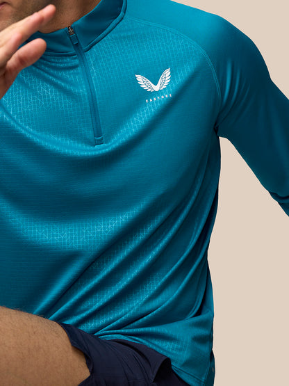 Close up of Dark Aqua Men’s Adapt Print 1/4 Zip Top featuring a geometric pattern, zip front and Castore logo on the left chest
