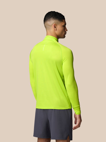 Back view of neon lime Adapt Training 1/4 Zip Top on a male model highlighting the high visibility color.