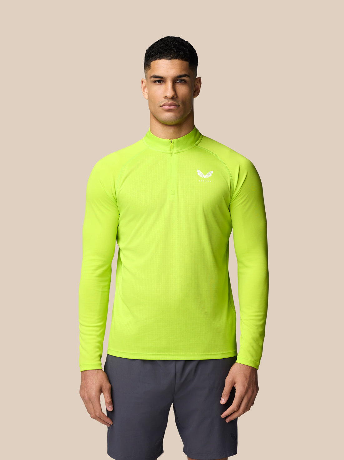 Male model in Acid Lime Adapt Training 1/4 Zip Top with front quarter zip and left chest logo.