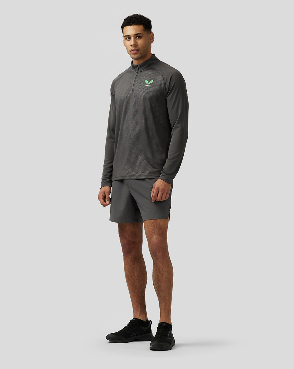 Front view of a man wearing Men's Adapt Print 1/4 Zip Top in gunmetal gray with stand collar, quarter zip, and green Castore left chest logo