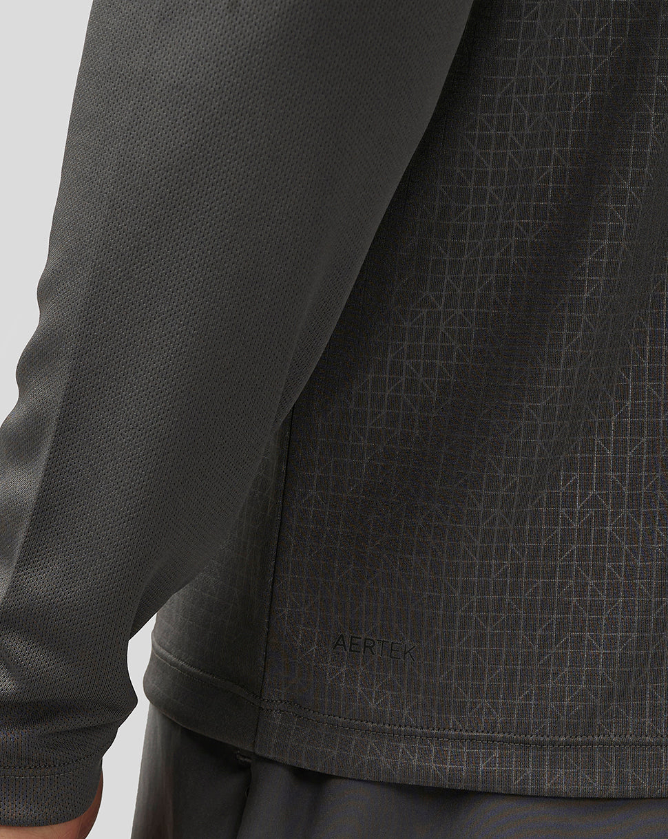 Close-up of back panel of dark gray long sleeve top with Aertek branding and geometric pattern detail