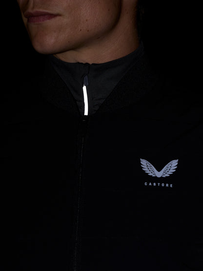Close-up of black Apex Training gilet collar with front zipper and Castore wing logo on the chest.