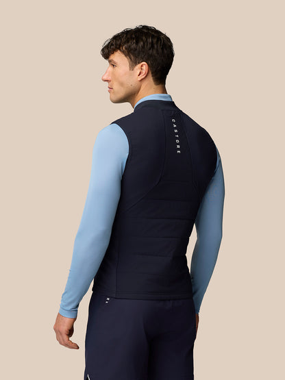 Back view of navy Apex Training Gilet showing vertical Castore branding on the upper back