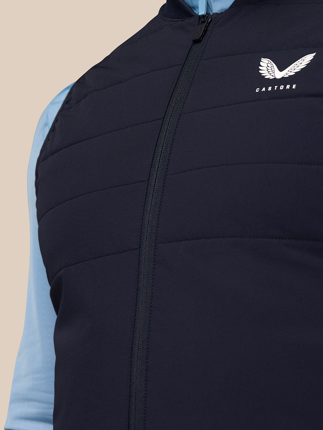 Close-up of the navy Gilet front showing the zipper and Castore logo on the chest.