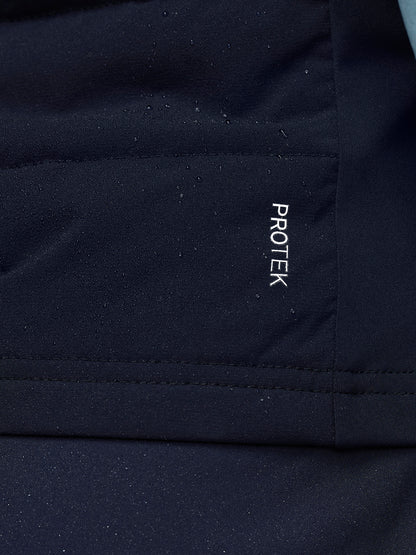 Close-up of navy Apex Training Gilet fabric with a vertical ProTek branding patch.