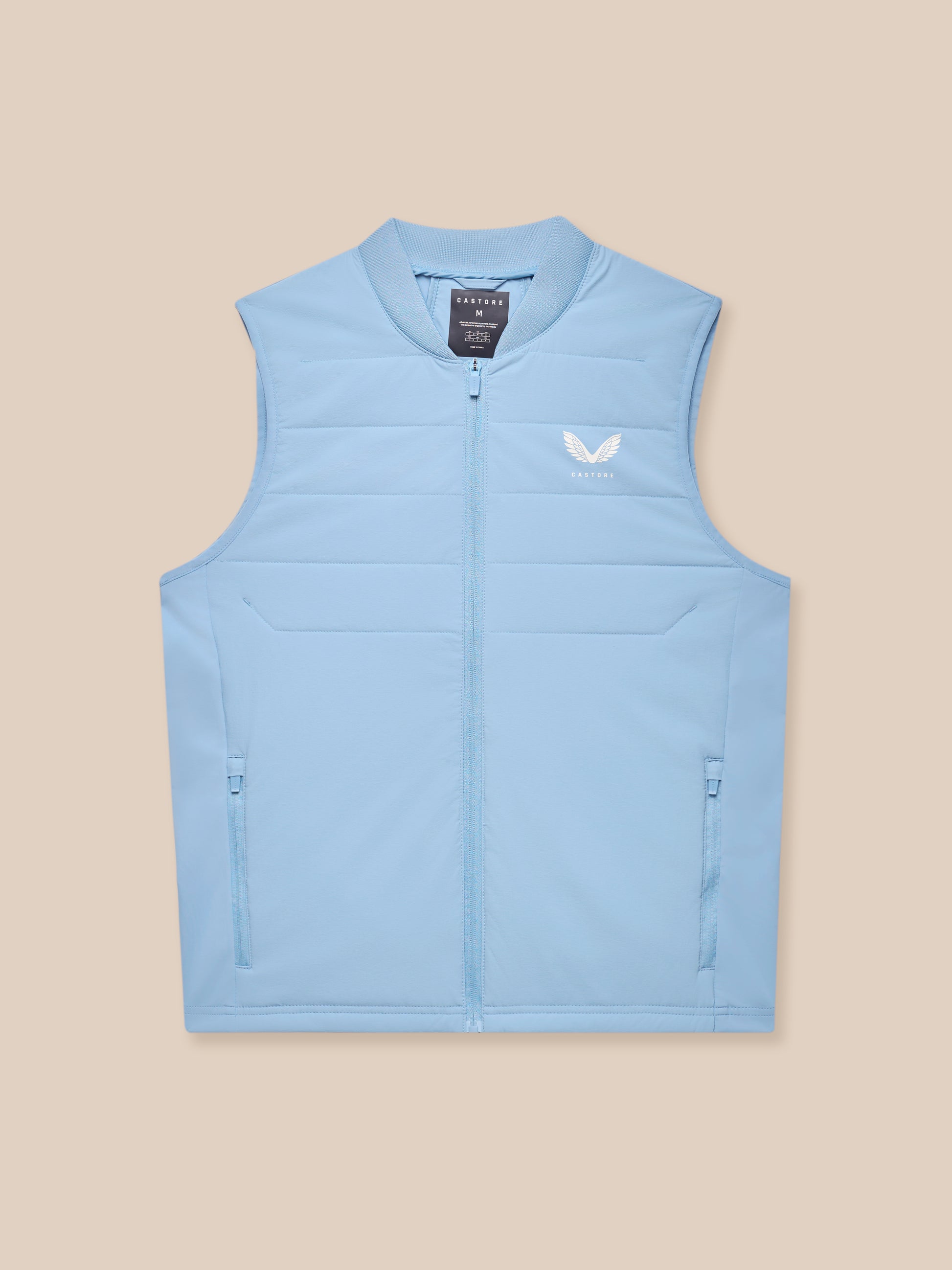 Close-up of sky blue Apex Training Gilet showing zipper and Castore logo on chest