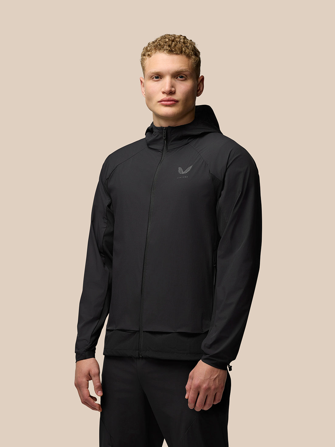 Front view of a man wearing a black Flex Hooded Jacket with full zip and left chest logo.