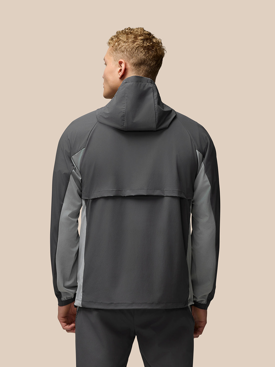 Back view of grey Flex Hooded Jacket featuring hood and contrasting panels