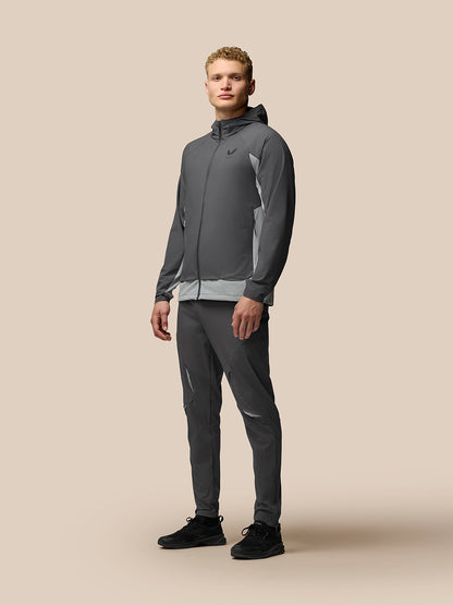 Male model wearing grey Flex Hooded Jacket with front zip and light side panels; Castore branding on chest