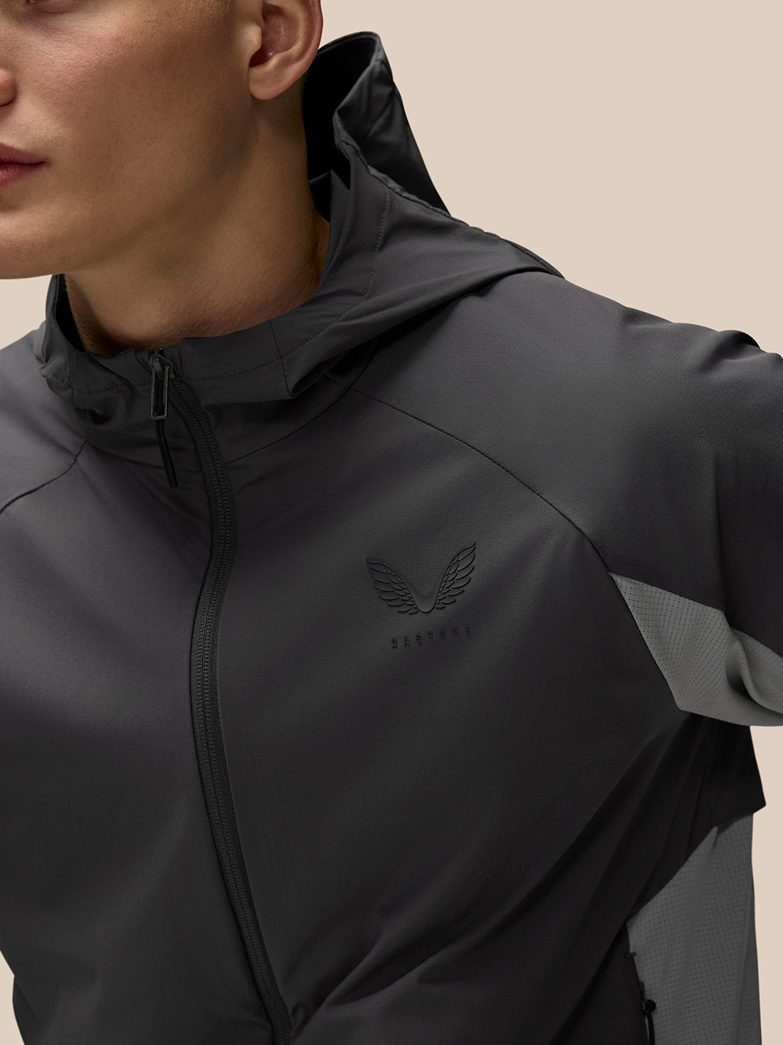 Close up of grey Flex Hooded Jacket on model highlighting hood and side panel details.