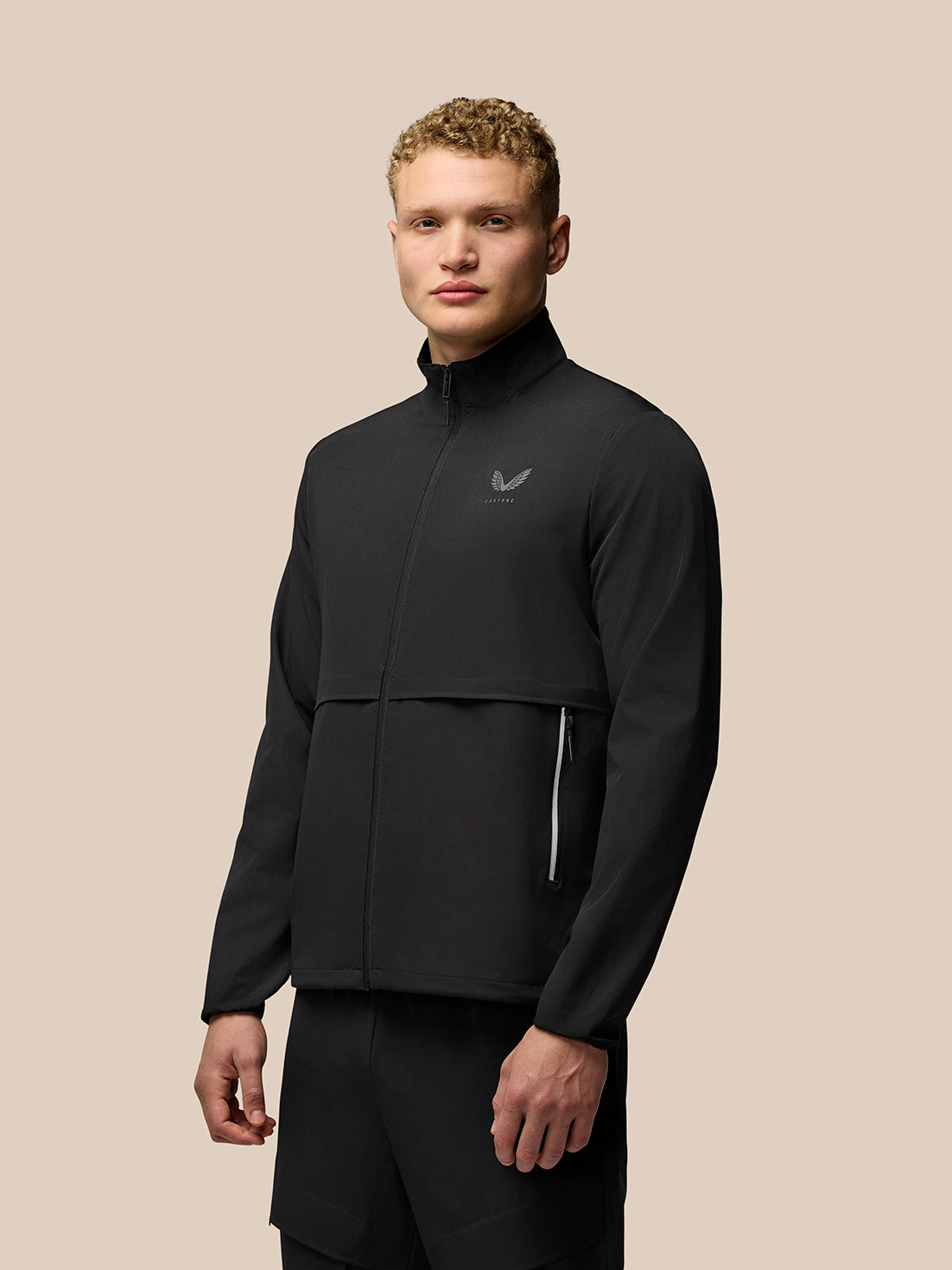 Male in black Flex Cargo Jacket with stand collar, full zip and zip pockets highlighting Protek fabric