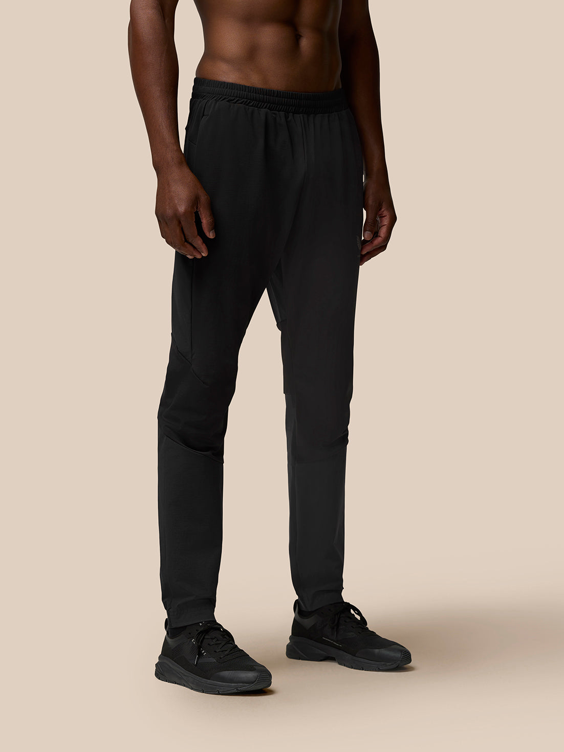 Close up of black Flow Joggers showing knee paneling and stretch fabric