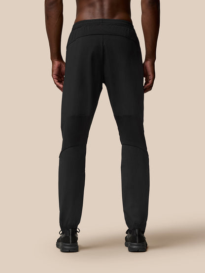 Back view of black Flow Training Joggers with panelled silhouette and tapered cuffs.