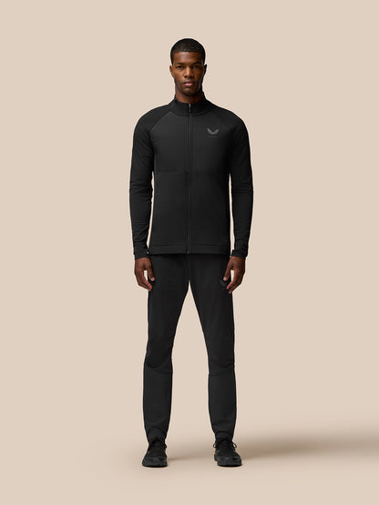 Male model wearing Flow Training Joggers in black with panelled design and Castore branding on thigh and calf