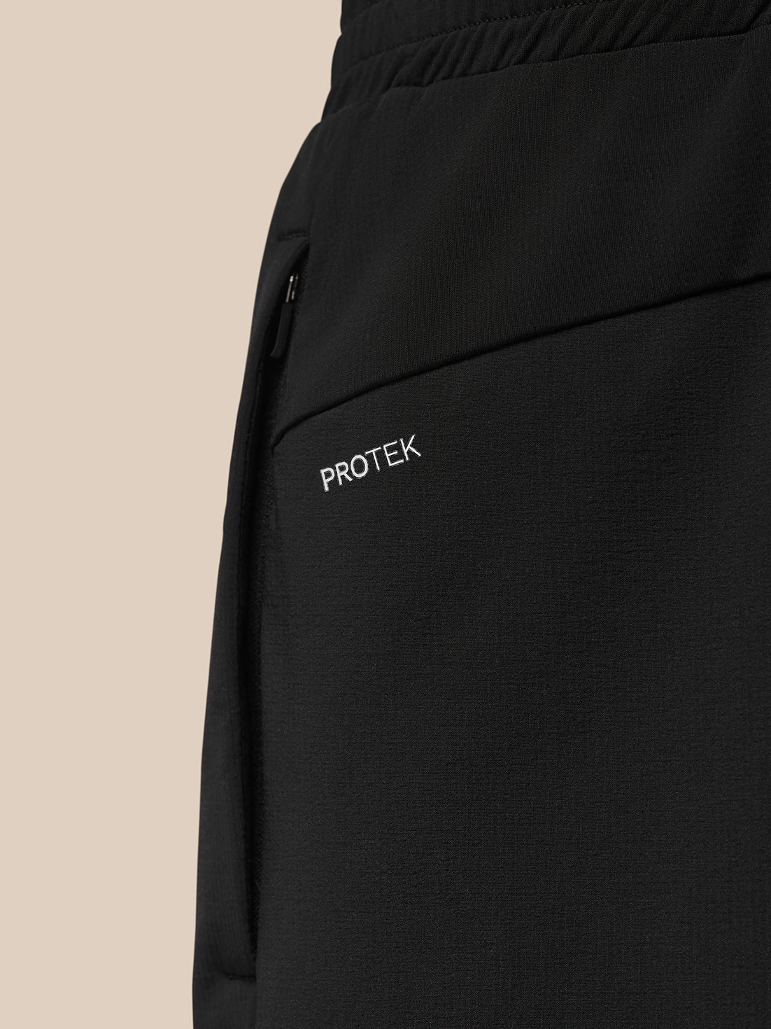Detail of side pocket area with zipper and ProTek label on Flow Training Joggers.